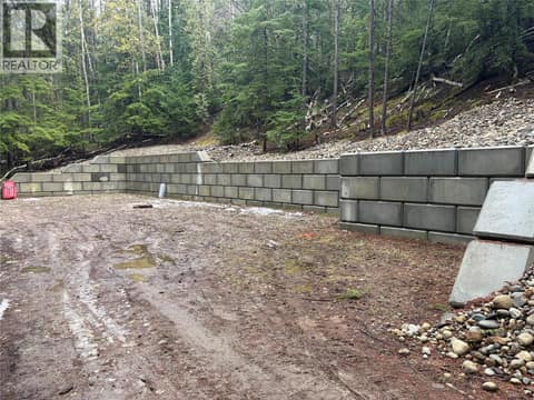 Owner created the retaining wall, there is enough space on th eproperty for 2 -3 3 Rv's and toys at 8700 Mabel Lake Road, Mabel Lake South, Lumby
