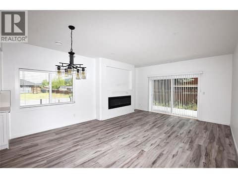 Living room with sliders to the back patio at 592 Nighthawk Avenue, Okanagan North, Vernon