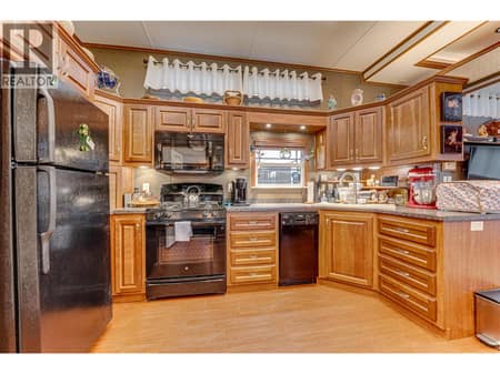 Large open kitchen with black appliances and gas stove at 8000 Highland Road Unit# 42, North BX, Vernon