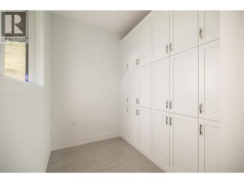 Storage Room off Mud Room at 689 Birdie Lake Place, Predator Ridge, Vernon