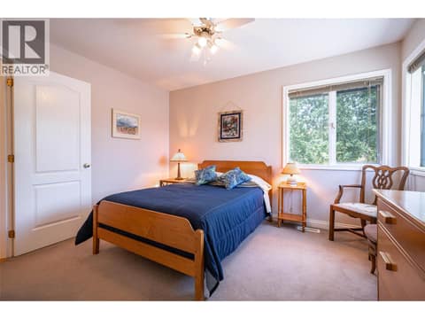 Upper Main Level: #3 Bedroom with Cheater Bathroom at 7821 Old Kamloops Road, Swan Lake West, Vernon