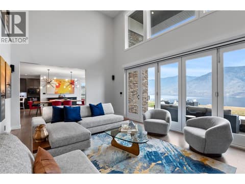 Living room open to the dining area at 229 Holloway Drive, Tobiano, Kamloops