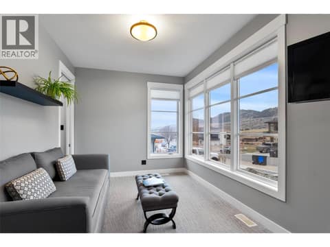 This bedroom has an intimate sitting area or could be a den at 229 Holloway Drive, Tobiano, Kamloops