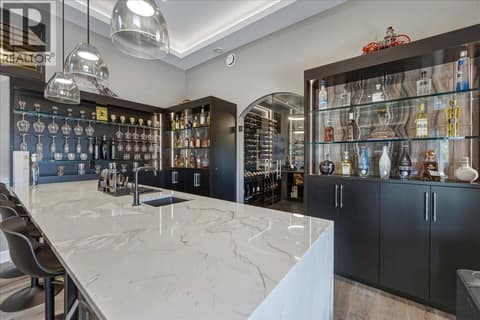 Wet bar with custom wine cellar at 2328 Arthur Court, McKinley Landing, Kelowna