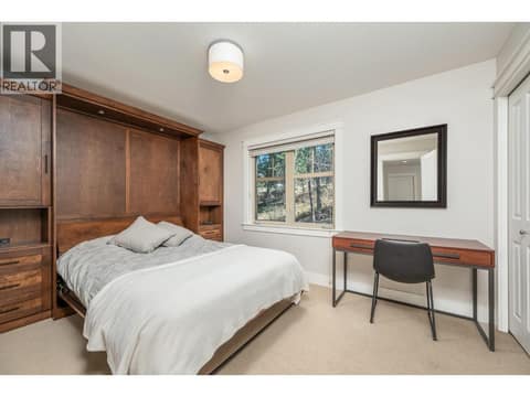 Comfort for your guests in this Multi-functional 2nd bedroom with space-saving Murphy bed unit with blt-in cabinetry and shelving. at 333 Longspoon Drive Unit# 26, Predator Ridge, Vernon