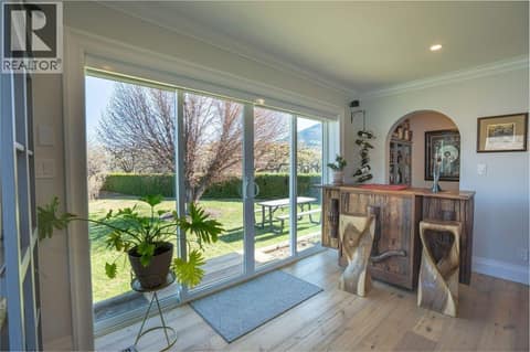 Living room looking towards bar nook & patio at 14807 89th Street, Osoyoos Rural