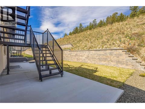 Backyard with access to rooftop deck off Kitchen at 2842 Copper Ridge Drive, Smith Creek, West Kelowna