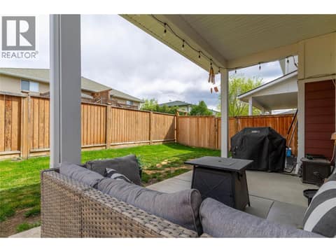 A large covered patio with some grass around too! at 1999 15 Avenue Unit# 9, East Hill, Vernon