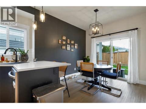 Dining room with access to a fully fenced outdoor space. at 1999 15 Avenue Unit# 9, East Hill, Vernon