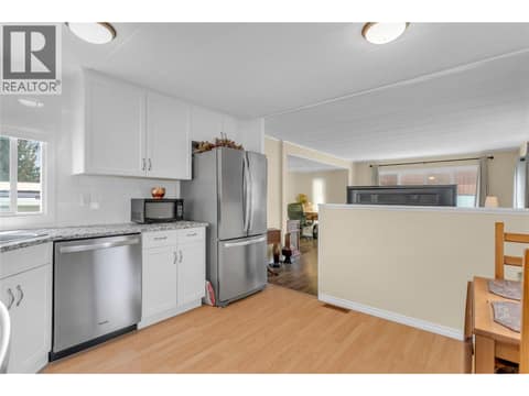 Kitchen view looking into the living room. at 12022 Pretty Road Unit# 16, Lake Country South West