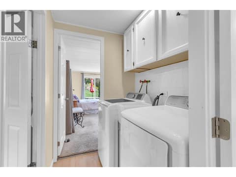 Laundry area between the bathroom and primary bedroom at 12022 Pretty Road Unit# 16, Lake Country South West