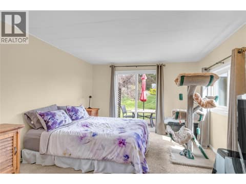 Primary bedroom. So bright with the sliding glass door leading to a cute deck and backyard. at 12022 Pretty Road Unit# 16, Lake Country South West