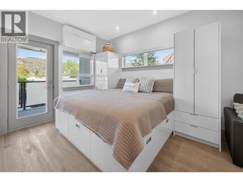 Queen size bed with tall built in cabinetry and under storage at 2555 Lakeshore Road Unit# 114, Okanagan Landing, Vernon
