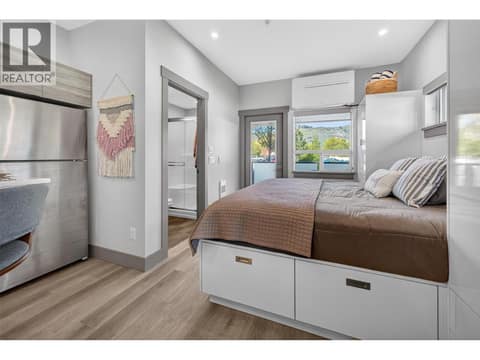 Queen size bed with tall built in cabinetry and under storage at 2555 Lakeshore Road Unit# 114, Okanagan Landing, Vernon