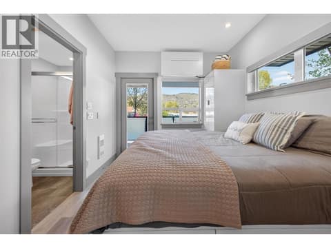 Queen size bed with tall built in cabinetry and under storage at 2555 Lakeshore Road Unit# 114, Okanagan Landing, Vernon
