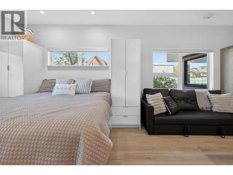Queen size bed with tall built in cabinetry and under storage at 2555 Lakeshore Road Unit# 114, Okanagan Landing, Vernon