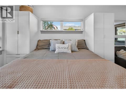 Queen size bed with tall built in cabinetry and under storage at 2555 Lakeshore Road Unit# 114, Okanagan Landing, Vernon