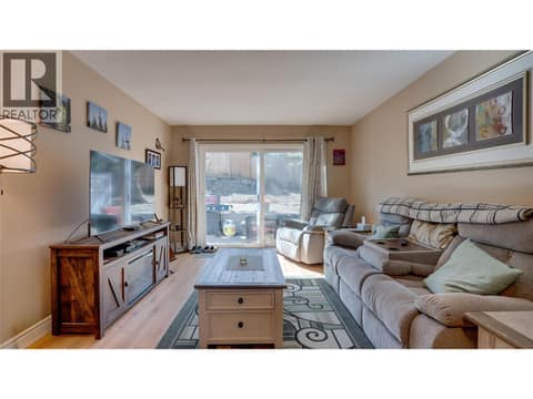 Main Floor: Living Room with rear outdoor access to small yard / patio space. at 1041 Middleton Way Unit# 102, Middleton Mountain Vernon