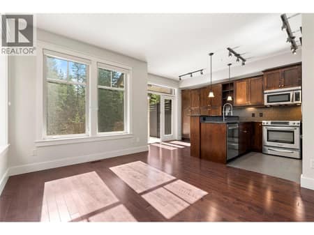 Kitchen flooded with south-facing light at 333 Longspoon Drive Unit# 35, Predator Ridge, Vernon