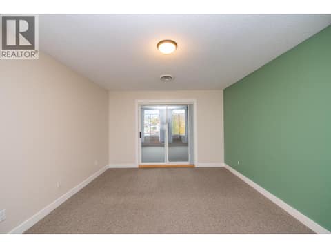 Patio doors lead to enclosed patio/deck area at 3929 22 Avenue Unit# 309, Mission Hill, Vernon