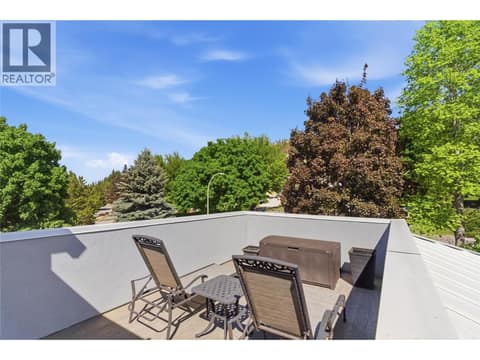 Front sun deck accessed from second level primary bedroom-and stairs that connects to the driveway at 2090 Bennett Road, McKinley Landing, Kelowna