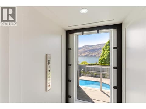 Glass elevator that connects all 3 levels of the home at 2090 Bennett Road, McKinley Landing, Kelowna