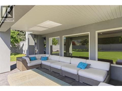 Large covered deck connected to the pool and backyard area at 2090 Bennett Road, McKinley Landing, Kelowna