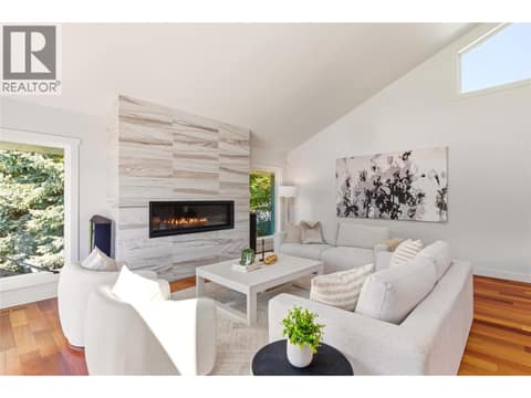 Main floor living room with access to the front deck at 2090 Bennett Road, McKinley Landing, Kelowna