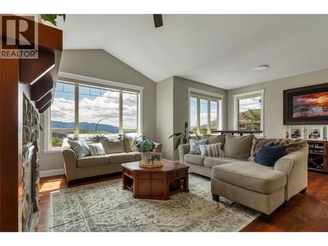 Fireplace, vaulted ceilings and large windows with lake view. at 1449 Red Mountain Place, Foothills, Vernon