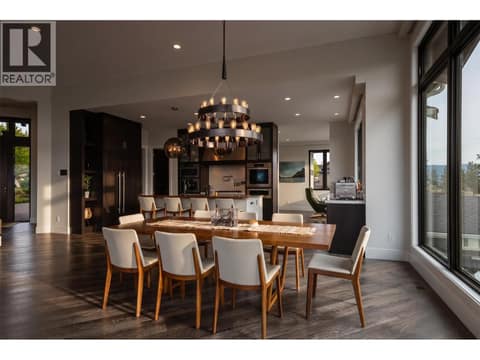 A chef’s dream in the heart of Wilden. Gourmet kitchen showcasing a massive central island with breakfast bar seating, custom cabinetry, Wolf gas range, and premium quartz countertops. at 162 Skyland Drive, Wilden, Kelowna