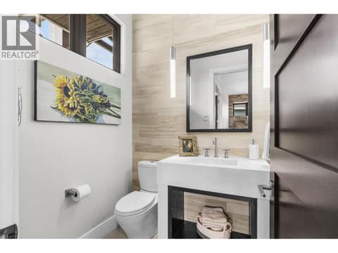 Elegant main-floor powder room. Sophisticatedly styled for guests and thoughtfully situated away from the main living and entertaining areas to ensure ultimate privacy and seamless layout design. at 162 Skyland Drive, Wilden, Kelowna