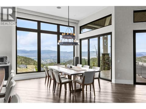 Elegant spaces for entertaining. Seamless flow from the gourmet kitchen to the dining area, featuring designer lighting and bright windows overlooking the private property. at 162 Skyland Drive, Wilden, Kelowna