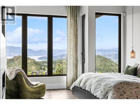 Spacious reading space in the primary suite at 162 Skyland Drive. Perfect for taking in the panoramic Wilden valley and mountain views on a slow morning or over an evening glass of Okanagan wine. at 162 Skyland Drive, Wilden, Kelowna
