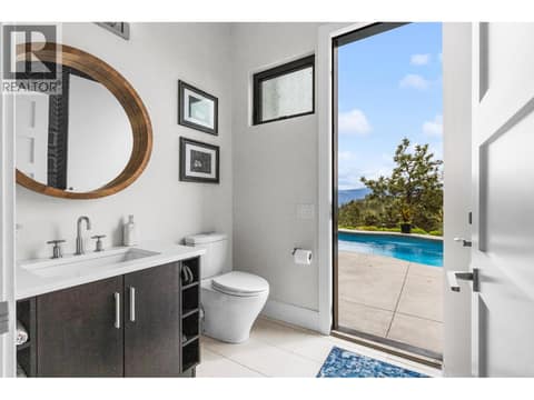 Stylish 3-piece lower-level bathroom beautifully finished with premium tile flooring, modern accents, and perfectly positioned for easy access from the recreation room and outdoor pool deck. at 162 Skyland Drive, Wilden, Kelowna
