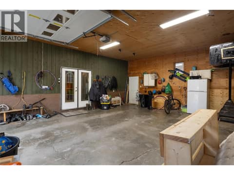Attached garage access to side foyer at 5712 6 Highway, Lavington, Vernon