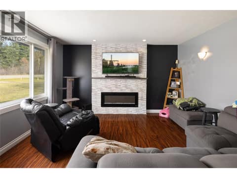 Living room with recently built feature wall and electric fireplace. at 5712 6 Highway, Lavington, Vernon