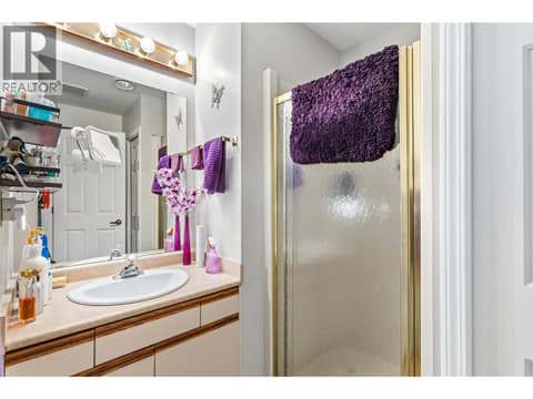 Main 3-piece bathroom includes a deep closet, offering plenty of extra storage and functionality. at 3900 27 Avenue Unit# 49, Westmount, Vernon