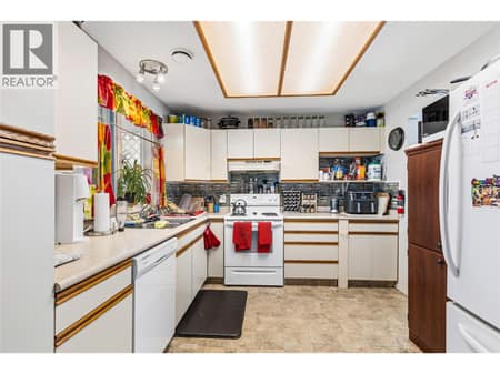 Spacious white kitchen offering ample cabinetry, great workspace, and a clean timeless design. at 3900 27 Avenue Unit# 49, Westmount, Vernon