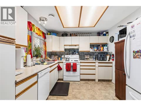 Spacious white kitchen offering ample cabinetry, great workspace, and a clean timeless design. at 3900 27 Avenue Unit# 49, Westmount, Vernon