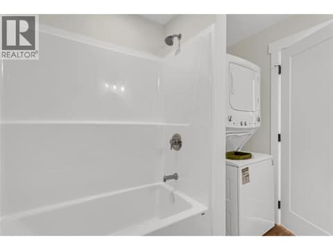 Tub Shower and Laundry in Bathroom at 2150 Montenegro Drive, Black Mountain, Kelowna