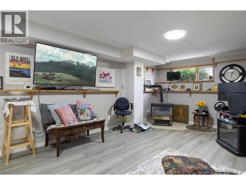 Family room with thermostat controlled gas fireplace at 3944 Cascade Drive, East Hill, Vernon