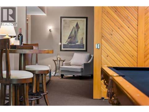 Sliding barn doors lead to media room at 108 Mashie Crescent, Predator Ridge, Vernon