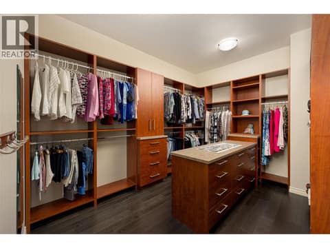 Large walk-in closet with built in features and island. at 10726 Nighthawk Road Unit# 60, Lake Country North West