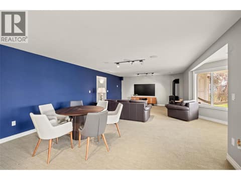 Large windows fill the space with light. at 10726 Nighthawk Road Unit# 60, Lake Country North West