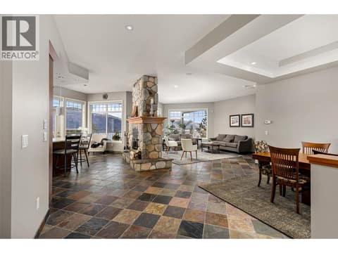 Open concept dining, living and kitchen anchored by wood-burning fireplace. at 10726 Nighthawk Road Unit# 60, Lake Country North West