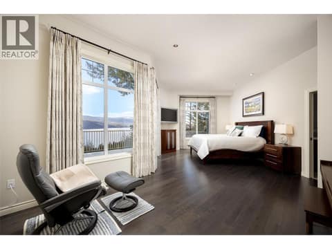 Primary bedroom with lounge space and patio access. at 10726 Nighthawk Road Unit# 60, Lake Country North West