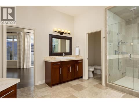 Travertine counters, dual sinks, water closet with toilet and bidet. at 10726 Nighthawk Road Unit# 60, Lake Country North West