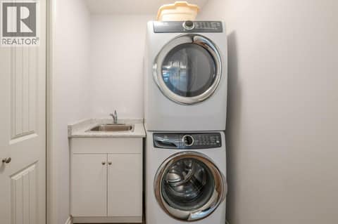 Laundry room with storage closet - main level at 2450 Radio Tower Road Unit# 38, Oliver Rural
