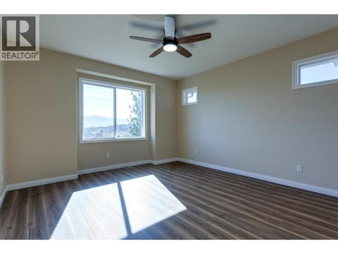 Main floor primary bedroom at 1084 Aurora Heights, West Kelowna Estates