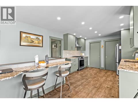 Granite countertops with eating bar at 6902 Old Kamloops Road, Swan Lake West, Vernon